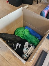 Large box of lighting and film equipment — green screens, t…
